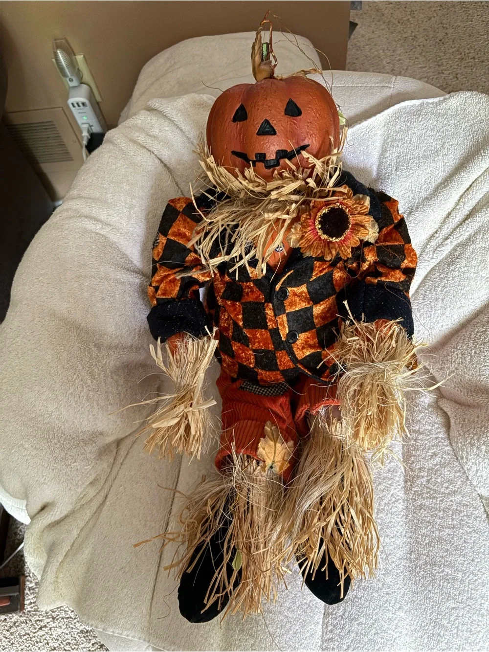 Cute resin head pumpkin doll with checkered jackets, cords, & straw accents.